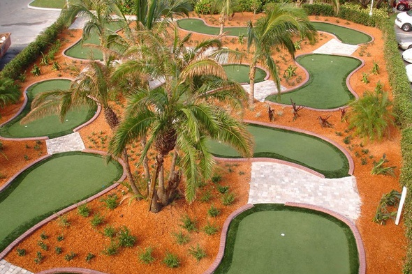 Huntsville Aerial view of a mini golf course with synthetic grass and palm trees.